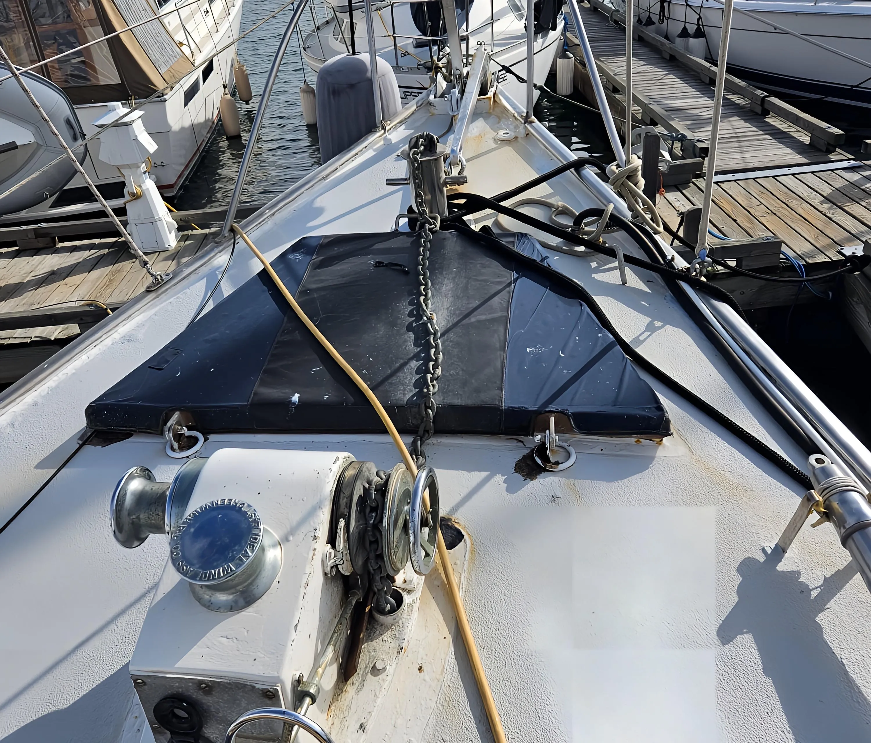 1969 Custom Rhodes Motorsailer Steel Ketch docked, showcasing deck and winch details.