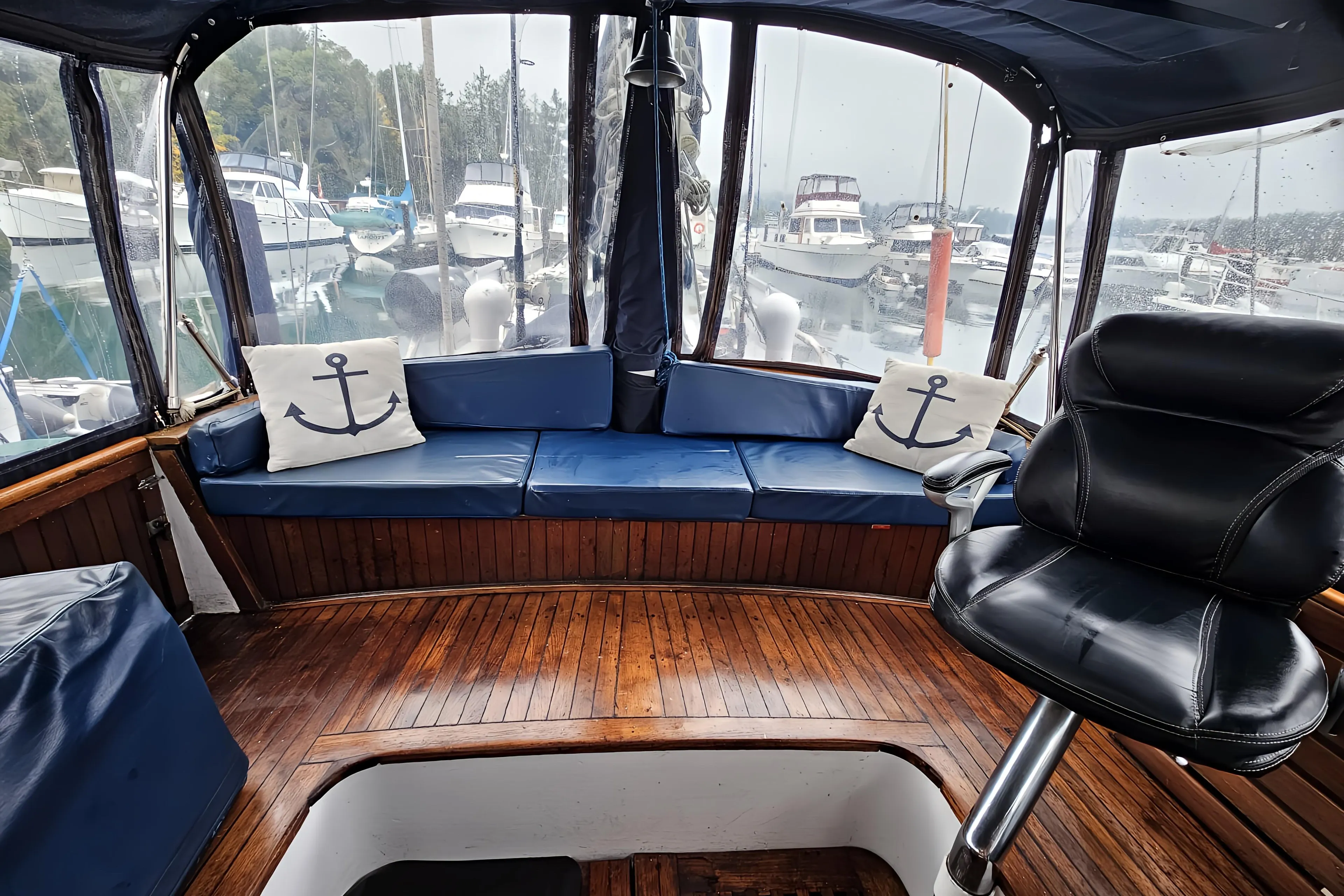 Interior of 1969 Rhodes Motorsailer Steel Ketch with blue seating and nautical decor.