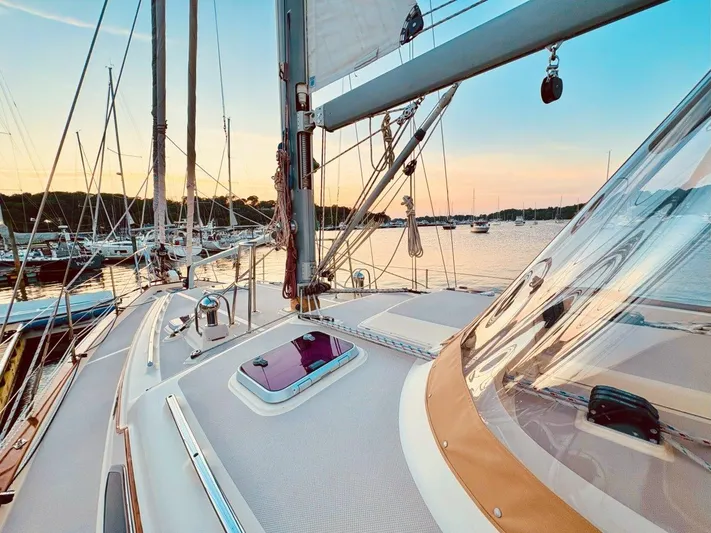 Calliope Yacht Photos Pics 2007 Island Packet 485 sailboat deck at sunset in a marina.