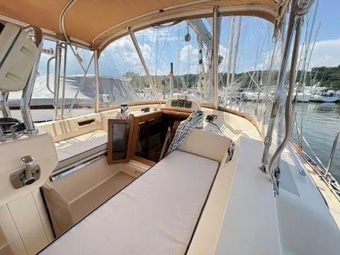 Calliope Yacht Photos Pics 2007 Island Packet 485 sailboat cockpit with cushioned seating and marina view.