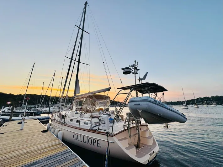 Calliope Yacht Photos Pics 2007 Island Packet 485 sailboat docked at sunset with dinghy attached.