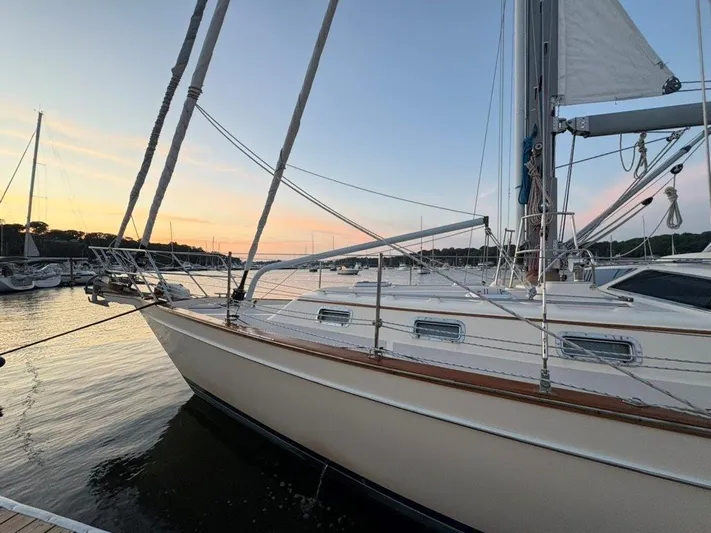 Calliope Yacht Photos Pics Sailboat Island Packet 485, 2007 model, docked at sunset with serene water view.