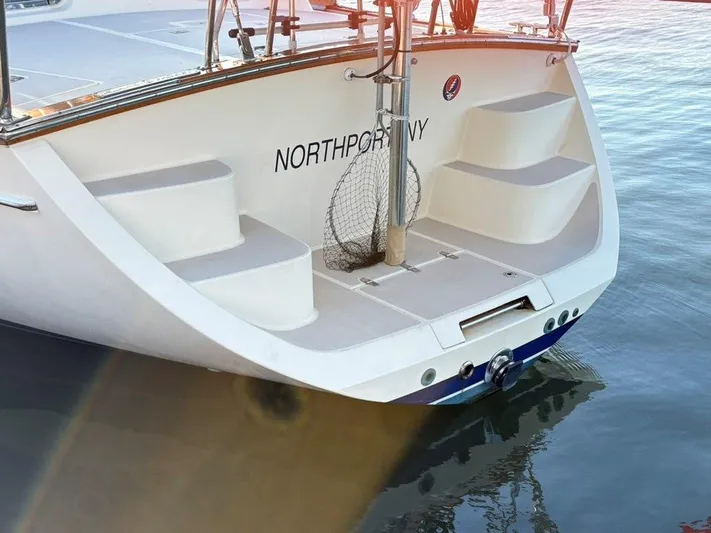 Calliope Yacht Photos Pics 2007 Island Packet 485 yacht stern with steps, docked on calm water.