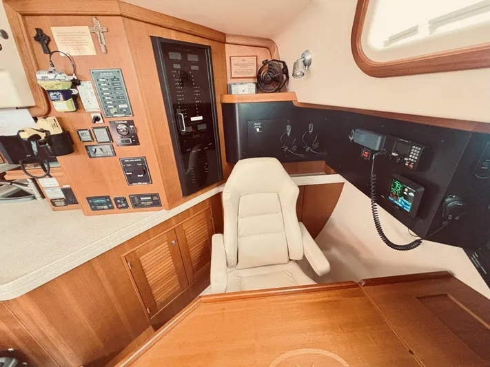 Calliope Yacht Photos Pics Navigation station of 2007 Island Packet 485 yacht with control panels and seating.