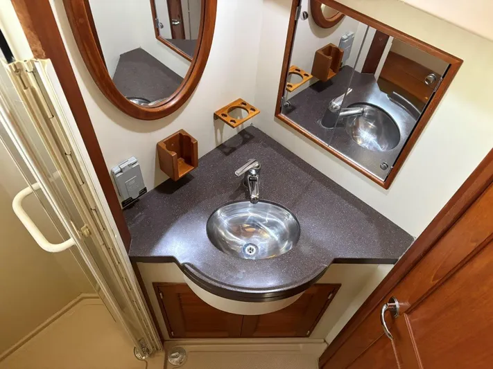 Calliope Yacht Photos Pics Luxurious bathroom in 2007 Island Packet 485 yacht with modern sink and wooden accents.