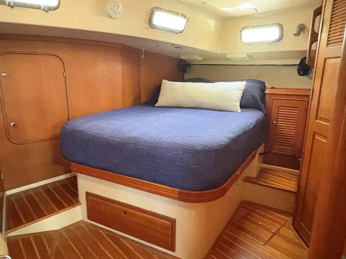 Calliope Yacht Photos Pics 2007 Island Packet 485 cabin with wooden interior and cozy bed.