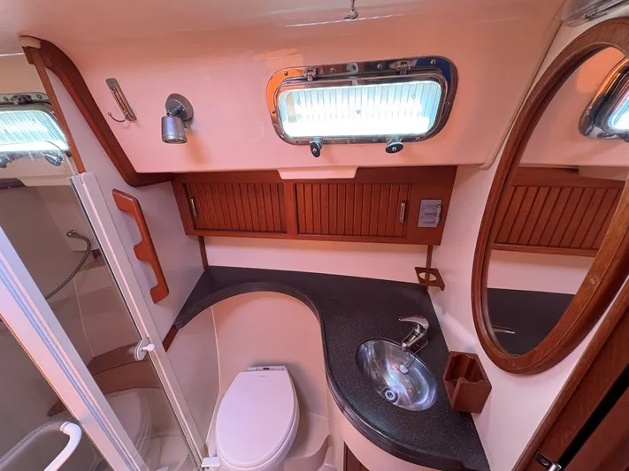Calliope Yacht Photos Pics Luxurious 2007 Island Packet 485 yacht bathroom with modern fixtures and wooden accents.