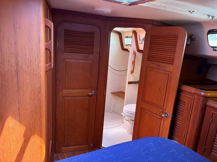 Calliope Yacht Photos Pics Interior of 2007 Island Packet 485 yacht showing wooden cabinetry and bathroom.