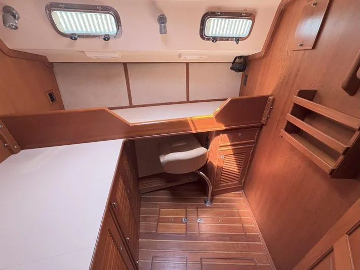 Calliope Yacht Photos Pics 2007 Island Packet 485 yacht interior with wooden cabinetry and seating area.