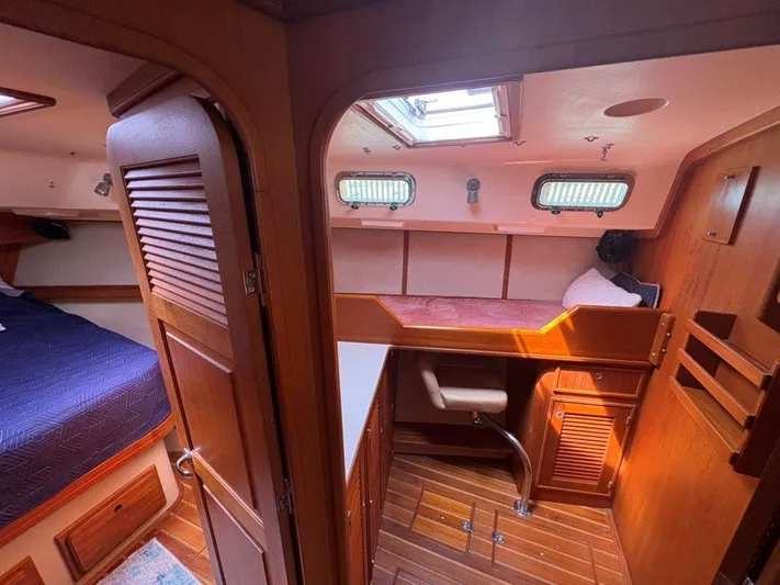 Calliope Yacht Photos Pics Interior of 2007 Island Packet 485 yacht with wooden cabinetry and cozy sleeping area.