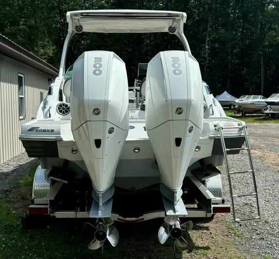  Yacht Photos Pics 2021 Crownline E305XS boat with dual 300 horsepower engines, parked outdoors.
