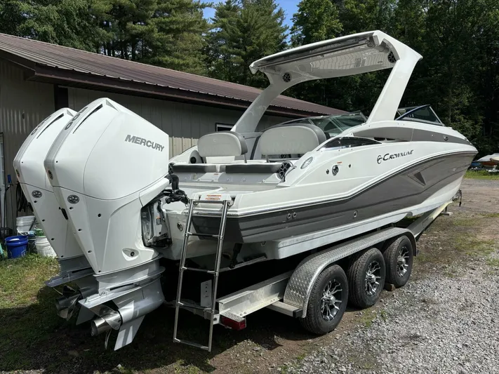  Yacht Photos Pics 2021 Crownline E305XS boat with dual Mercury engines on a trailer.