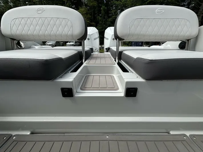  Yacht Photos Pics 2021 Crownline E305XS boat seating area with cushioned seats and step.