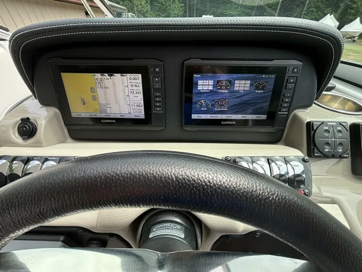  Yacht Photos Pics 2021 Crownline E305XS dashboard with dual Garmin displays and steering wheel.