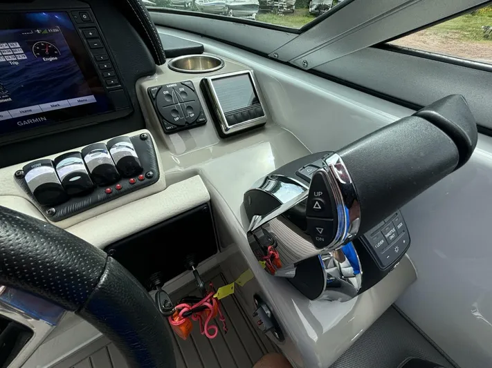  Yacht Photos Pics Control panel of 2021 Crownline E305XS boat with steering and navigation systems.