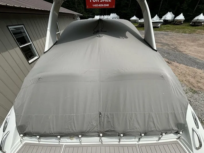  Yacht Photos Pics 2021 Crownline E305XS boat covered, for sale sign visible, parked outdoors.