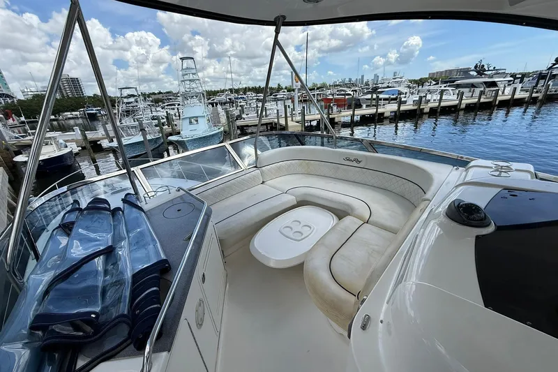  Yacht Photos Pics 2005 Sea Ray 500 Sedan Bridge yacht interior with marina view, featuring spacious seating area.