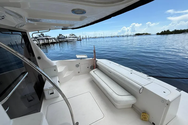  Yacht Photos Pics 2005 Sea Ray 500 Sedan Bridge yacht deck with marina view, featuring sleek seating and open water.