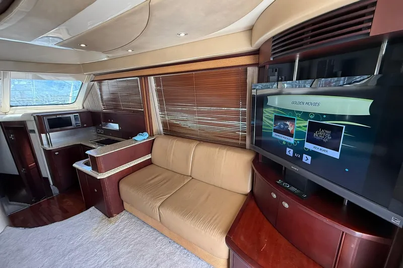  Yacht Photos Pics Luxurious interior of 2005 Sea Ray 500 Sedan Bridge with sofa and entertainment system.