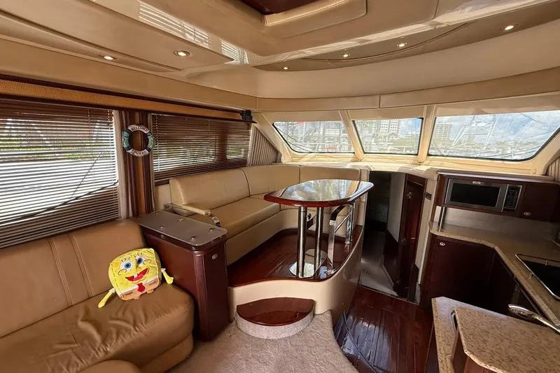  Yacht Photos Pics Luxurious interior of 2005 Sea Ray 500 Sedan Bridge yacht with plush seating and modern amenities.