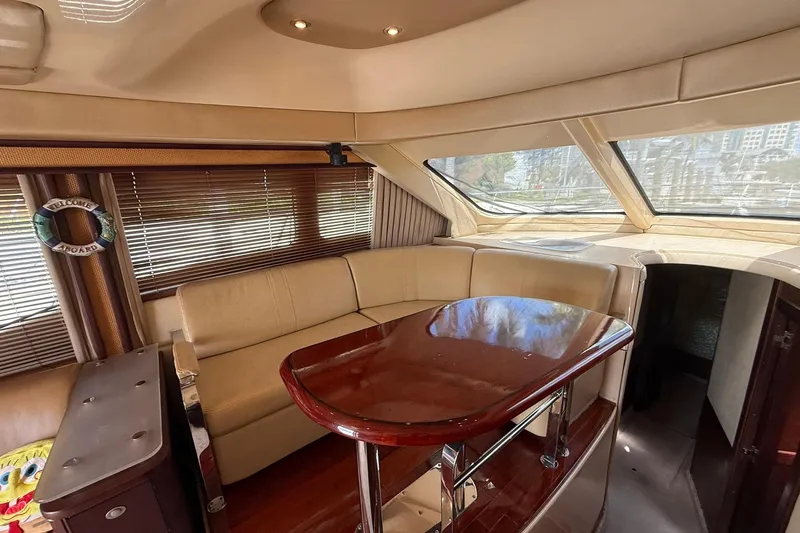  Yacht Photos Pics Luxurious interior of 2005 Sea Ray 500 Sedan Bridge yacht with elegant seating and table.