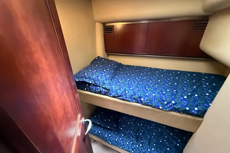  Yacht Photos Pics 2005 Sea Ray 500 Sedan Bridge cabin with bunk beds and blue patterned bedding.