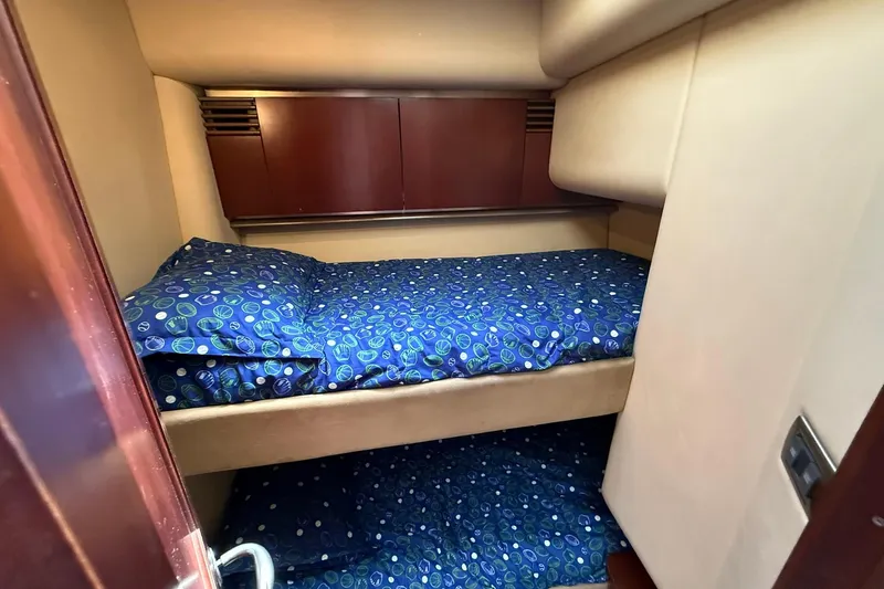 Yacht Photos Pics 2005 Sea Ray 500 Sedan Bridge cabin with bunk beds and blue patterned bedding.