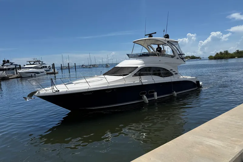  Yacht Photos Pics 2005 Sea Ray 500 Sedan Bridge yacht docked in a marina under a clear blue sky.