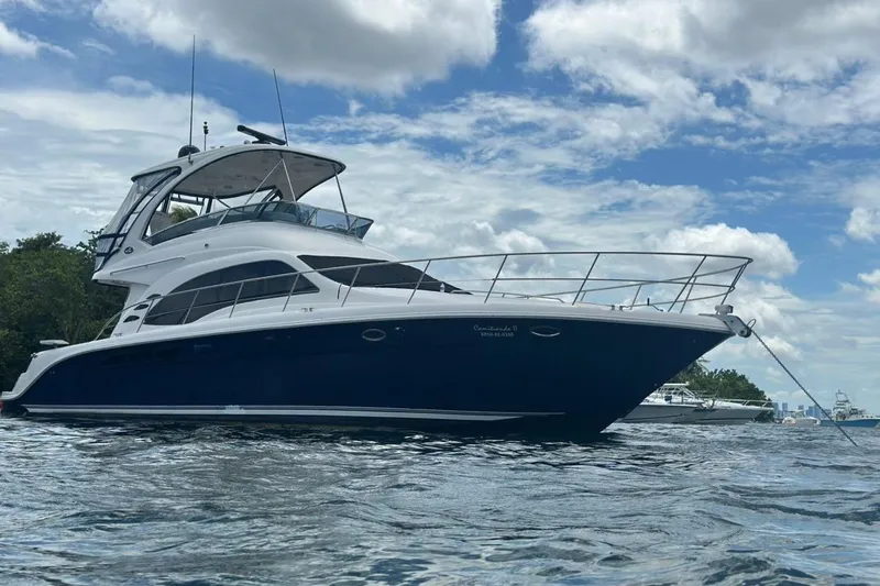  Yacht Photos Pics 2005 Sea Ray 500 Sedan Bridge yacht anchored on a calm, scenic waterway.
