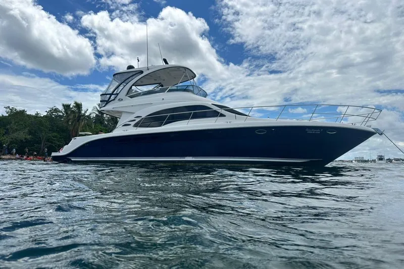  Yacht Photos Pics 2005 Sea Ray 500 Sedan Bridge yacht on water, under partly cloudy sky.