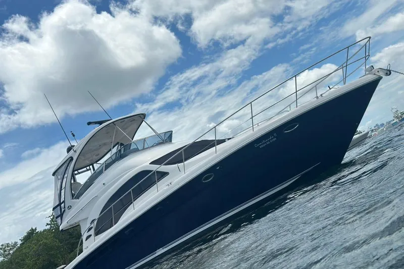  Yacht Photos Pics 2005 Sea Ray 500 Sedan Bridge yacht on water under cloudy sky.