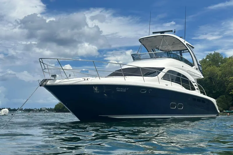  Yacht Photos Pics 2005 Sea Ray 500 Sedan Bridge yacht on calm water under a blue sky.