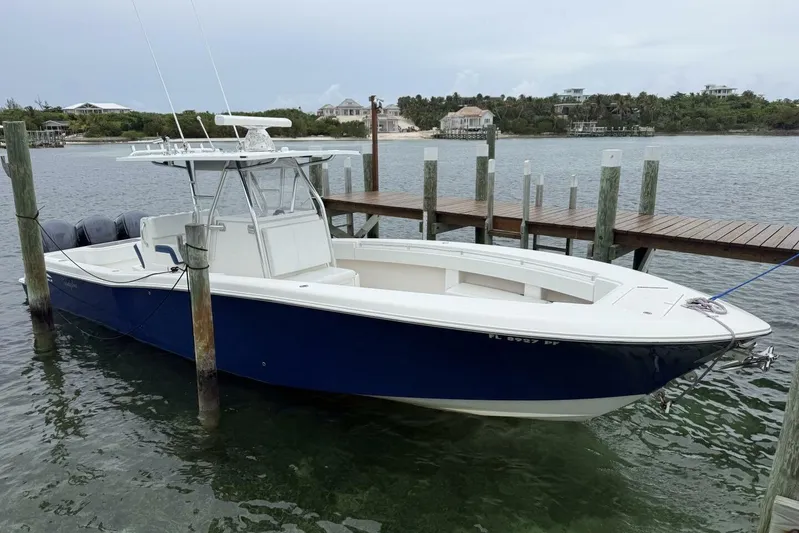 Sindylou Yacht Photos Pics 2012 Invincible 36 Open Fisherman boat docked by wooden pier.