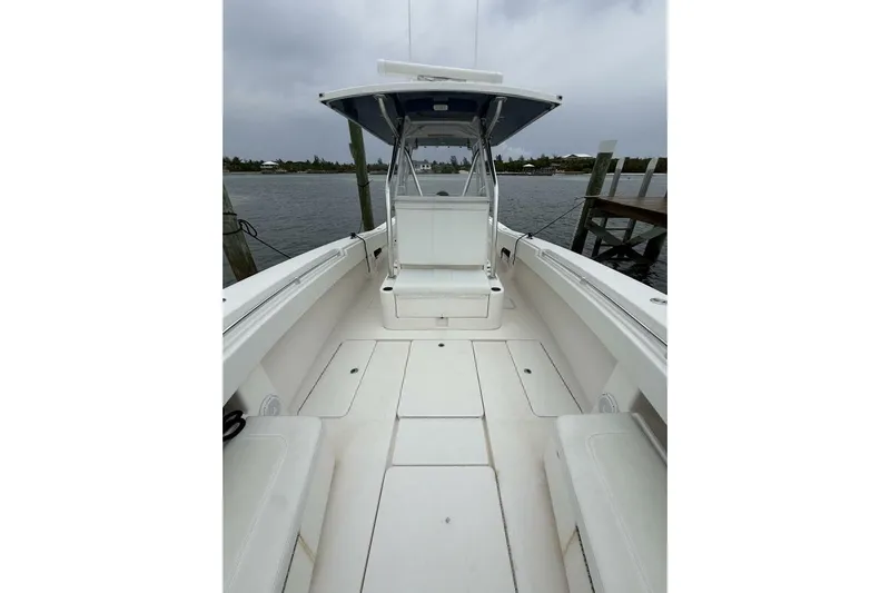 Sindylou Yacht Photos Pics 2012 Invincible 36 Open Fisherman boat interior with seating, docked by the water.