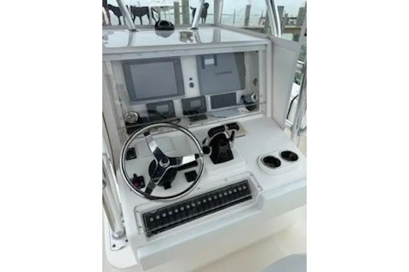 Sindylou Yacht Photos Pics 2012 Invincible 36 Open Fisherman boat console with steering wheel and navigation equipment.
