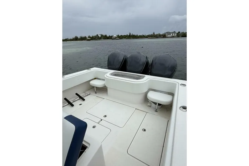 Sindylou Yacht Photos Pics 2012 Invincible 36 Open Fisherman boat with triple engines on calm water.