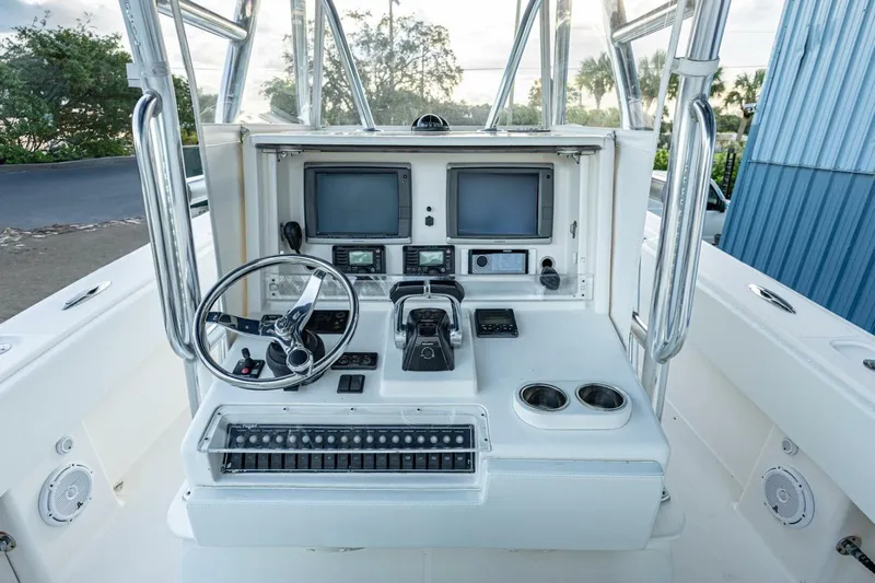 Sindylou Yacht Photos Pics 2012 Invincible 36 Open Fisherman boat console with steering wheel and navigation screens.