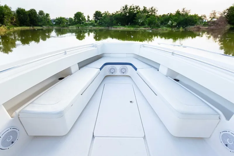 Sindylou Yacht Photos Pics 2012 Invincible 36 Open Fisherman boat interior with white seating, on a calm lake.