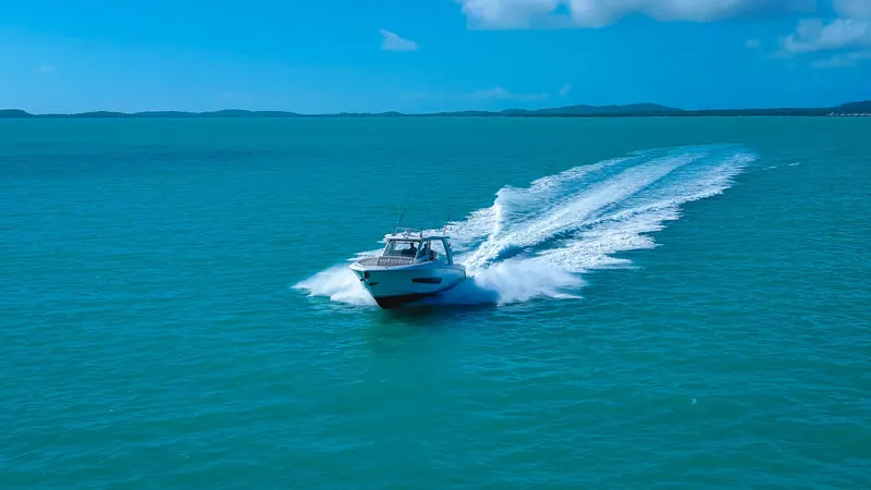  Yacht Photos Pics Boston Whaler 420 Outrage 2017 cruising on turquoise ocean under clear blue sky.