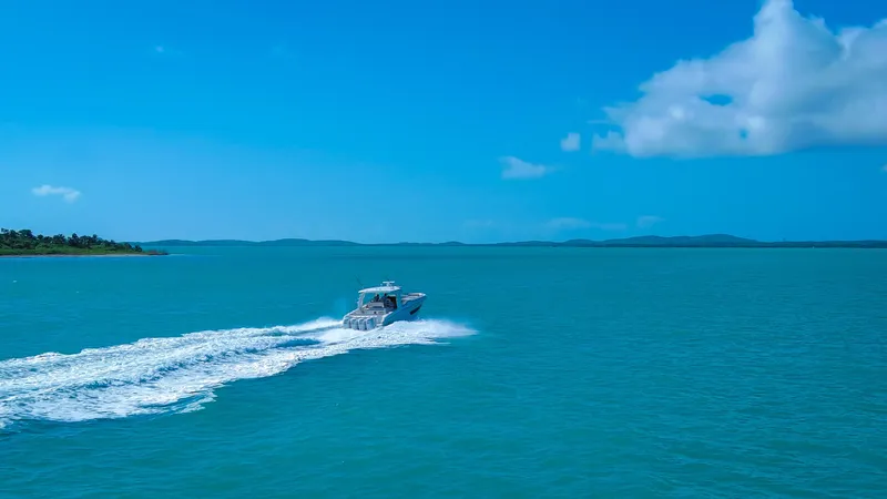  Yacht Photos Pics 2017 Boston Whaler 420 Outrage cruising on open blue sea under clear sky.