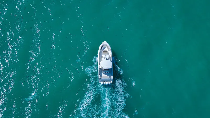  Yacht Photos Pics Aerial view of 2017 Boston Whaler 420 Outrage cruising on turquoise water.