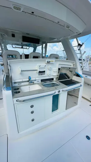  Yacht Photos Pics 2017 Boston Whaler 420 Outrage boat kitchen area with modern amenities and sleek design.