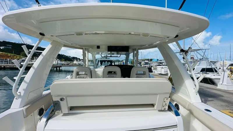  Yacht Photos Pics 2017 Boston Whaler 420 Outrage boat docked at marina, showcasing spacious seating and sleek design.