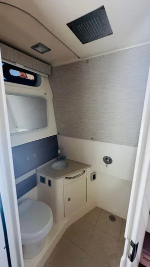  Yacht Photos Pics 2017 Boston Whaler 420 Outrage bathroom with modern fixtures and compact design.