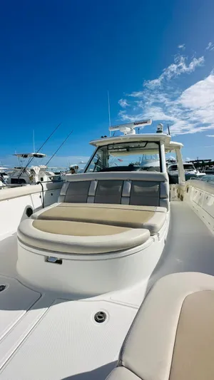  Yacht Photos Pics 2017 Boston Whaler 420 Outrage boat with spacious deck under clear blue sky.