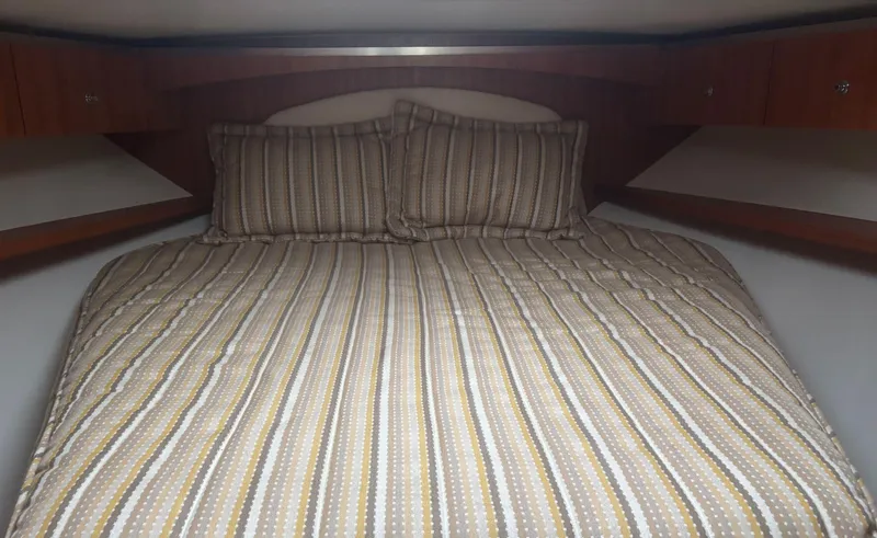  Yacht Photos Pics Cozy cabin bed in 2008 Tiara Yachts 3600 Open with striped bedding.