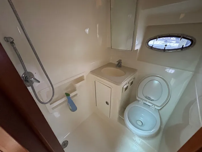  Yacht Photos Pics Bathroom interior of 2008 Tiara Yachts 3600 Open, featuring shower, sink, and toilet.