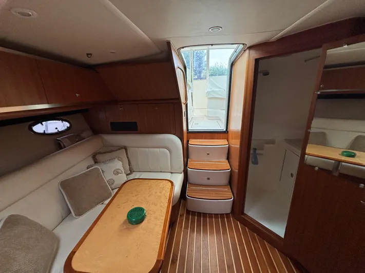  Yacht Photos Pics Interior of 2008 Tiara Yachts 3600 Open, featuring cozy seating and elegant wood finishes.