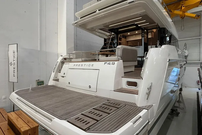  Yacht Photos Pics Luxury 2026 Prestige F4.9 yacht in showroom, showcasing elegant design and spacious deck.