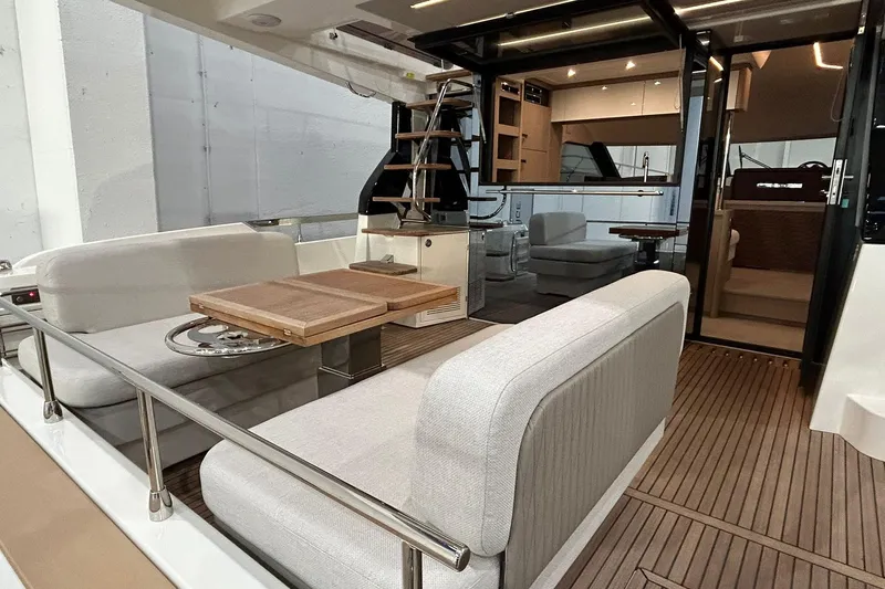  Yacht Photos Pics Luxurious 2026 Prestige F4.9 yacht interior with elegant seating and wooden flooring.